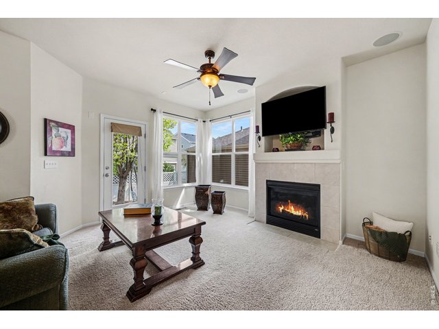 Property Photo 16 Inviting family room anchored by a tiled gas fireplace and built-in media nook.