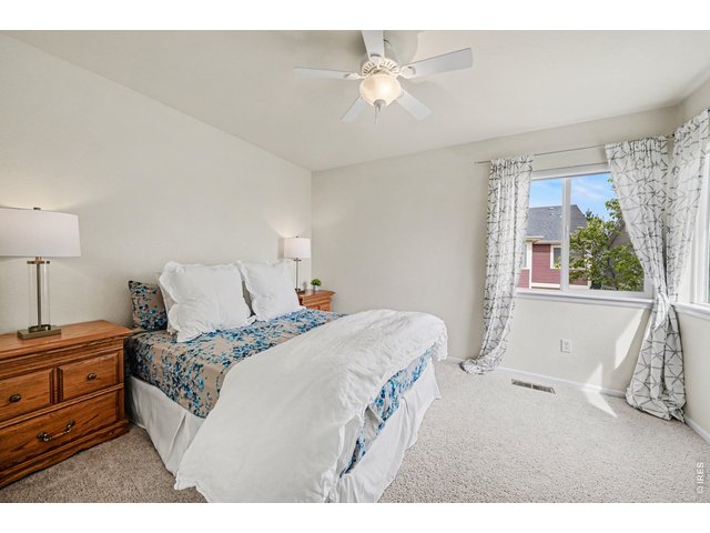 Property Photo 27 Comfortable secondary bedroom featuring a ceiling fan, and ample space for a full suite of furniture