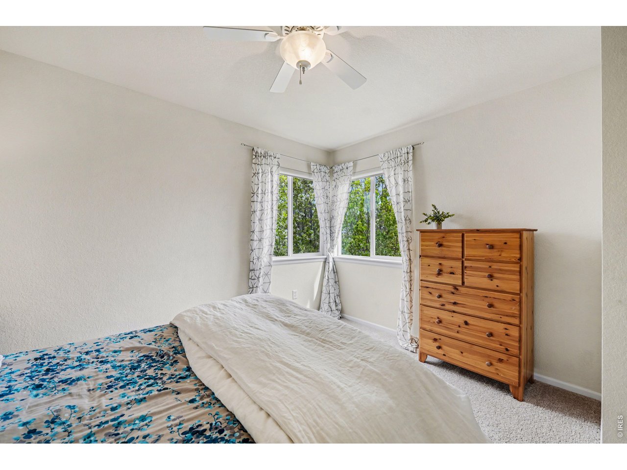 Bright and airy guest room with corner windows, perfect for family or visitors