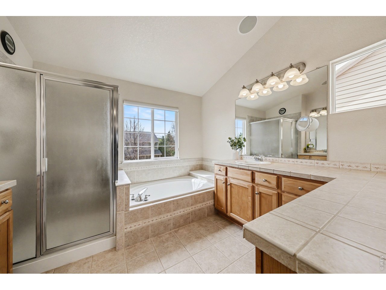 Relaxing primary bathroom showcasing a large soaking tub and a dedicated walk-in shower for a true retreat experience