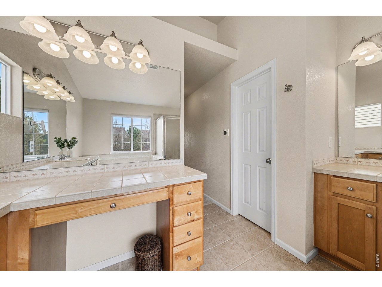 Functional and stylish primary ensuite with dual sinks, expansive counter space, and a private water closet