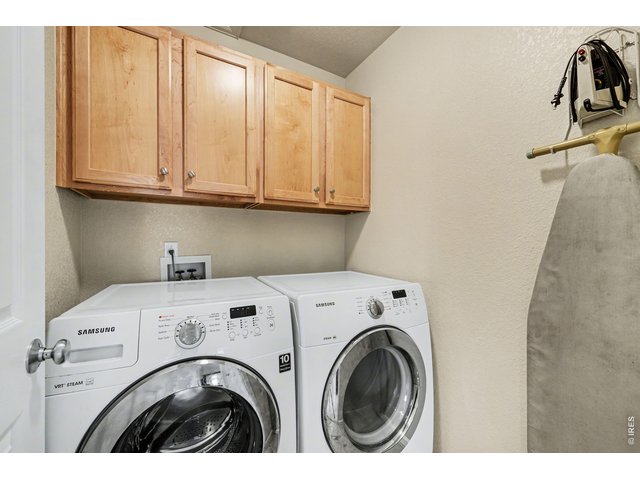 Property Photo 30 Convenient upper-level laundry room with overhead cabinetry for easy organization