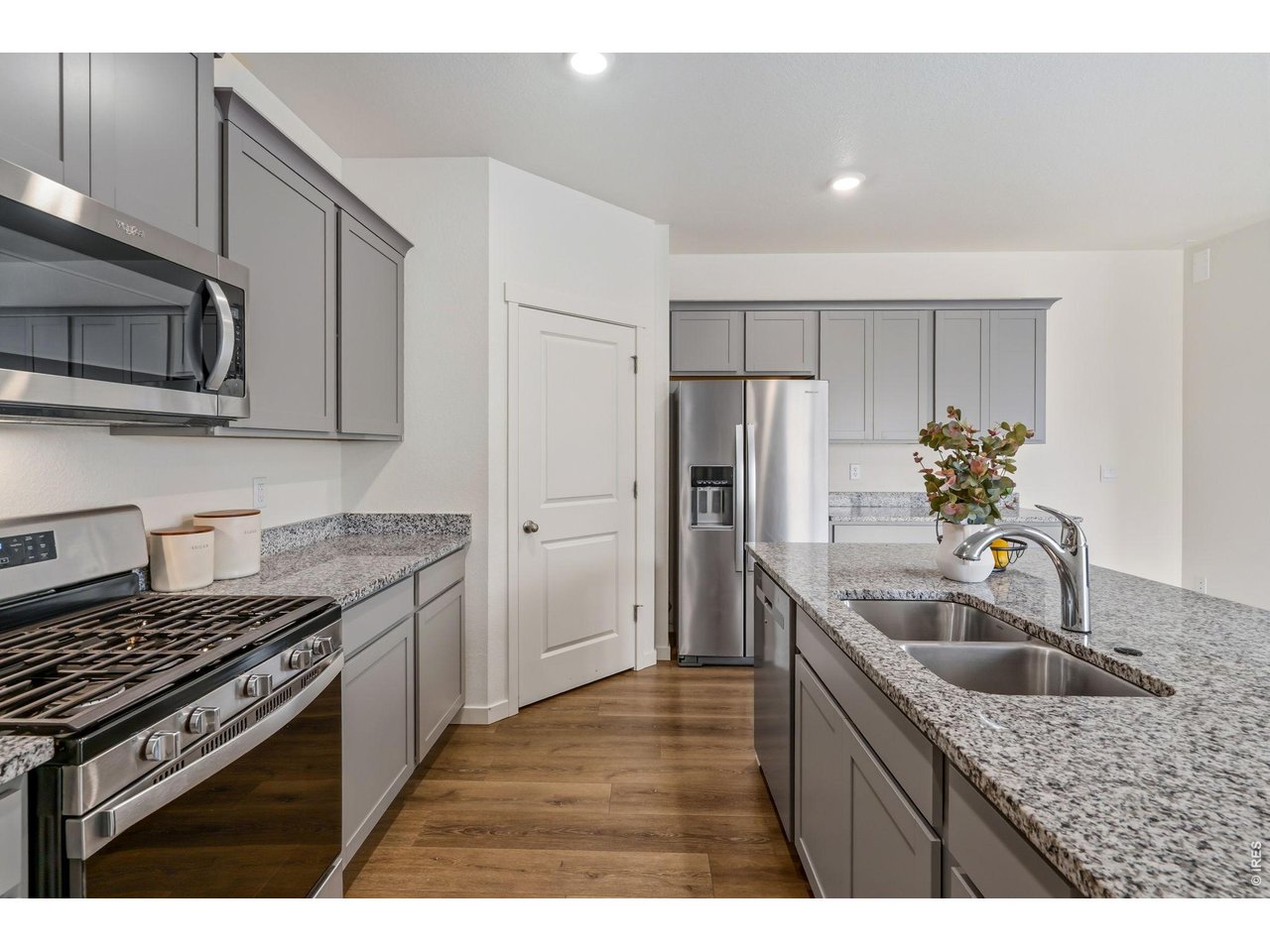 High-end kitchen appliances including a gas range. 