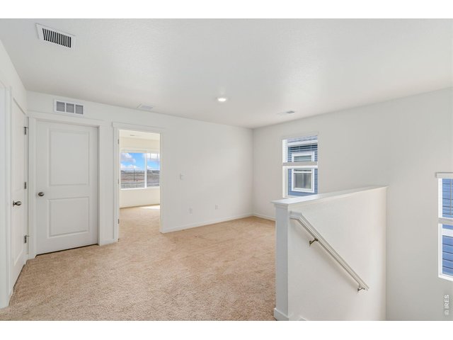 Property Photo 17 Upstairs, you'll find a spacious loft/flex area, a convenient laundry room, and four well-appointed bedrooms. 