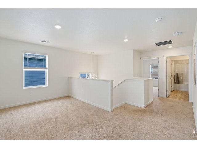 Property Photo 21 Upstairs, you'll find a spacious loft/flex area, a convenient laundry room, and four well-appointed bedrooms. 