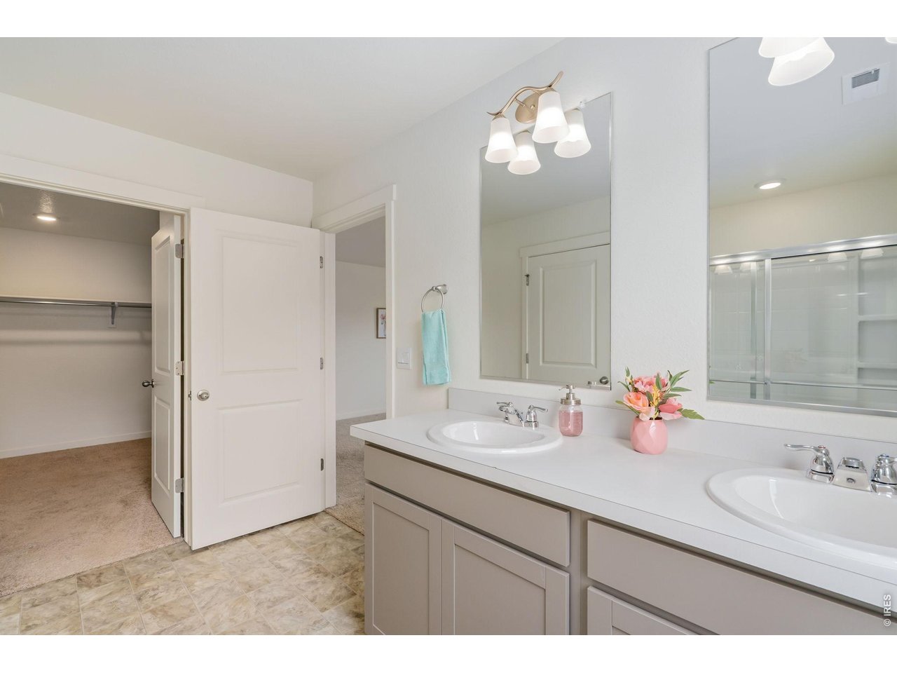 The impressive primary suite includes a private bath with double sinks and a generous walk-in closet. 