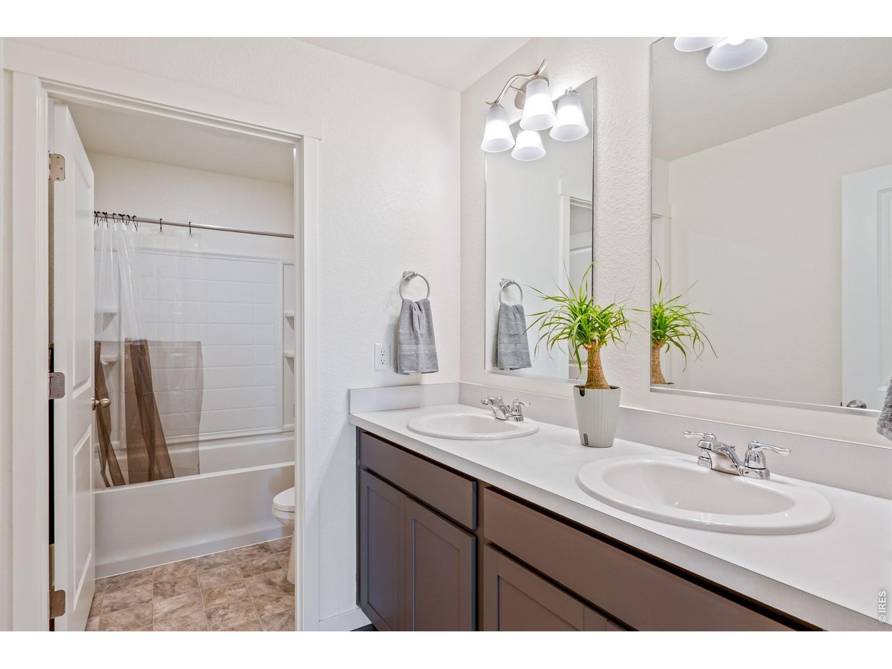 Full upstairs bathroom featuring double sinks