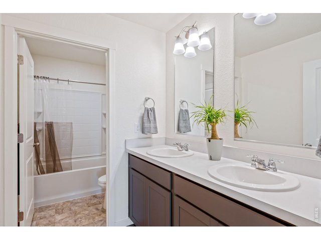 Property Photo 18 Full upstairs bathroom featuring double sinks