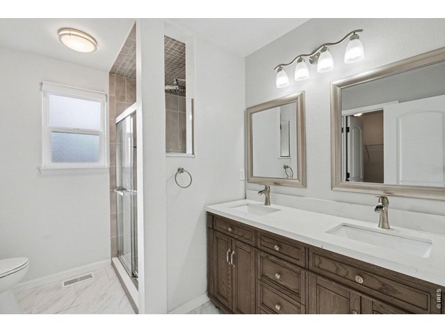 Property Photo 9 Primary bathroom with dual sinks and a walk-in shower