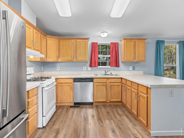 Property Photo 11 The kitchen features stainless steel appliances including a gas range
