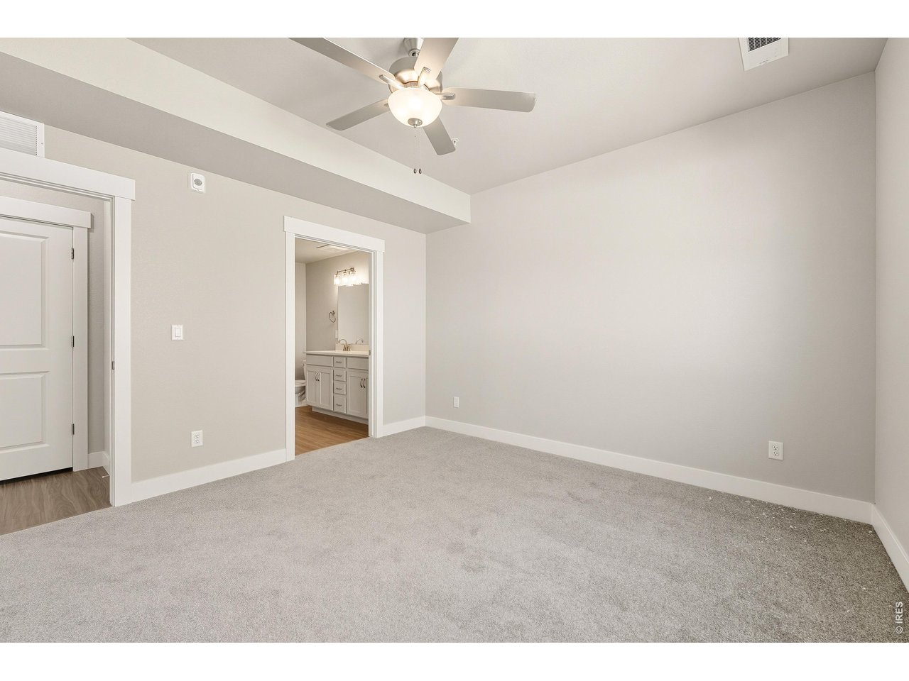 Property Photo 10 Primary bedroom with ceiling fan included. 