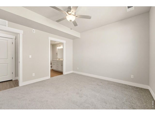 Property Photo 10 Primary bedroom with ceiling fan included. 