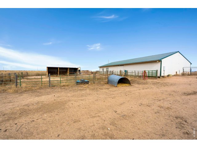 Property Photo 23 View of barn and paddock from back of home