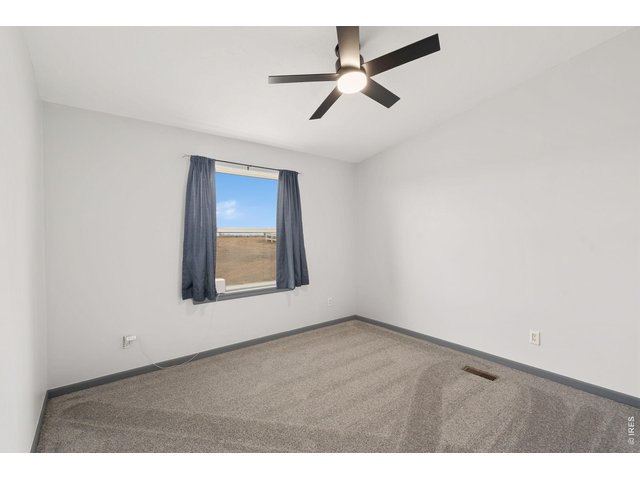 Property Photo 20 Bedroom 2 with new carpet and fan