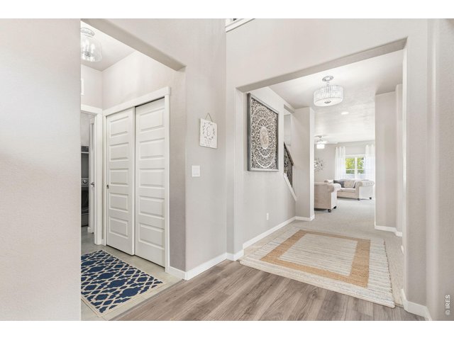 Property Photo 6 Inviting front entry with two-story openness, convenient coat closet off garage entry