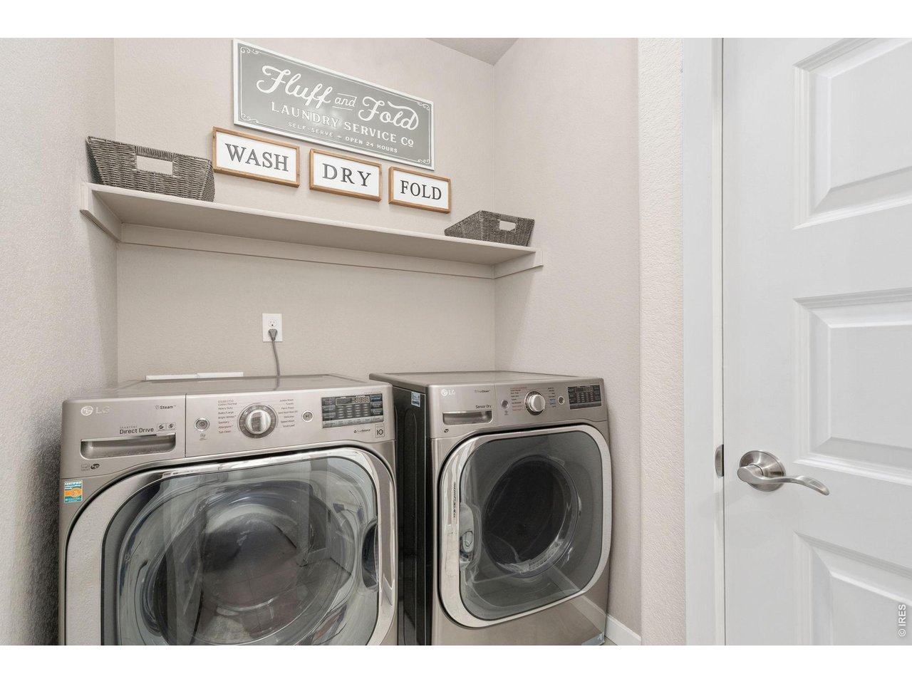 Spacious laundry room with added storage and shelving