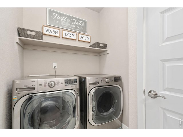 Property Photo 8 Spacious laundry room with added storage and shelving