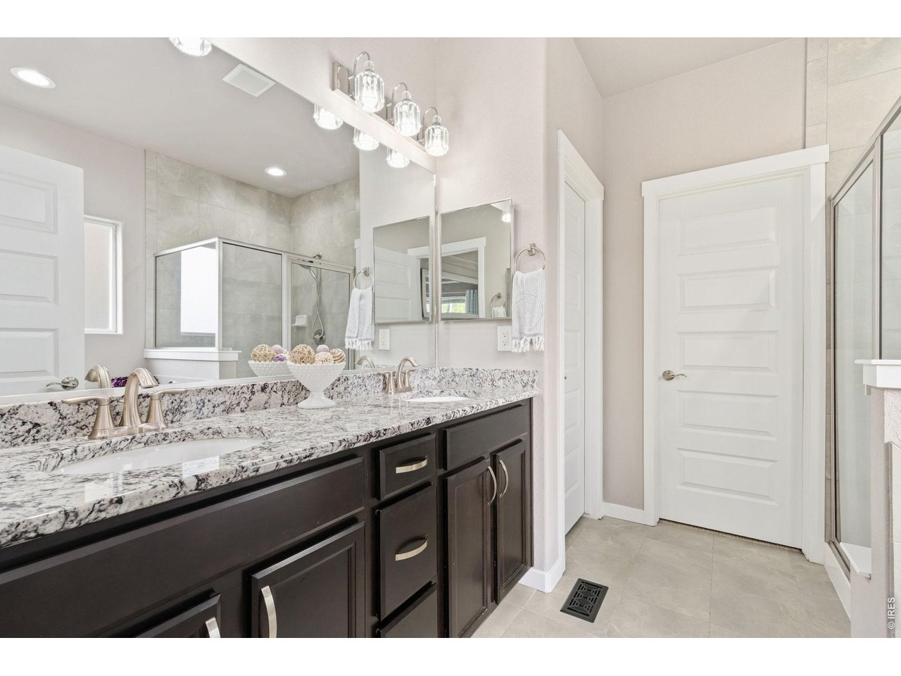 Dual sink vanity with plenty of space, walk-in closet with ample storage