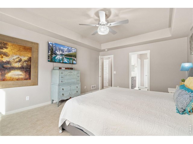 Property Photo 20 Spacious primary bedroom with coffered ceiling detail