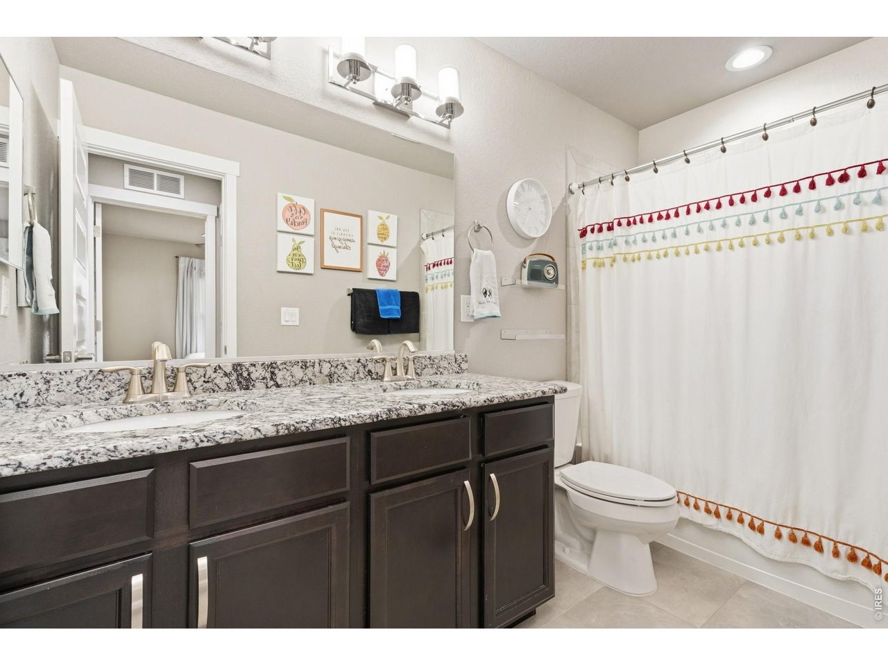 Full upstairs bathroom with dual sinks and granite countertops