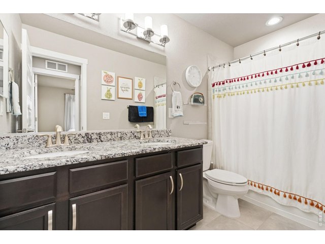 Property Photo 30 Full upstairs bathroom with dual sinks and granite countertops