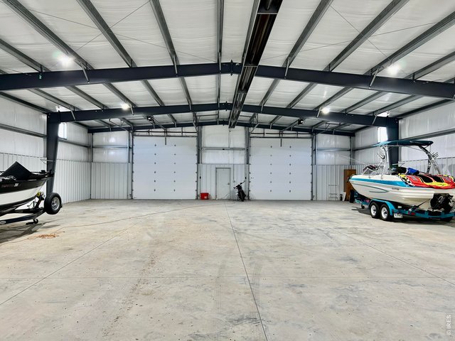 Property Photo 12 Interior looking towards overhead doors and walk-in door