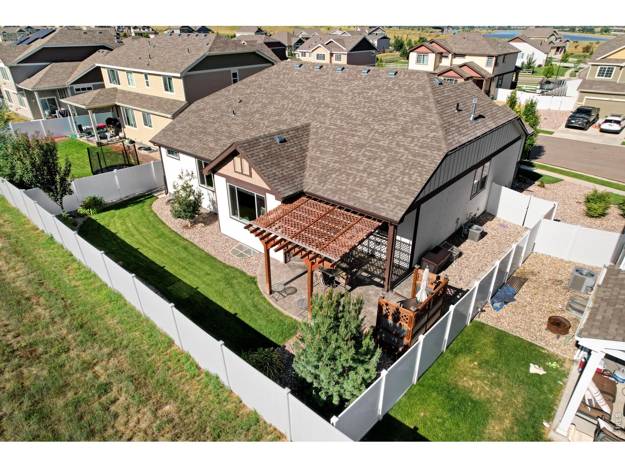 Fully Fenced Low Maintenance Backyard with Shady Pergola, Custom BBQ Corner that backs to a small Farmstead