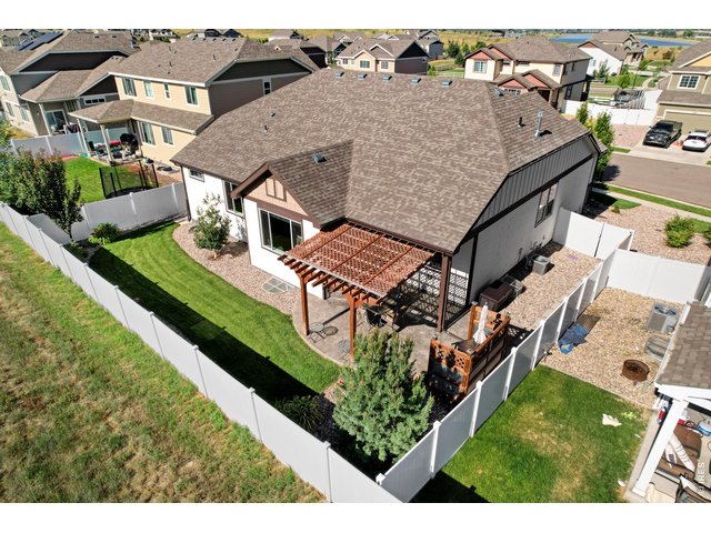 Property Photo 3 Fully Fenced Low Maintenance Backyard with Shady Pergola, Custom BBQ Corner that backs to a small Farmstead
