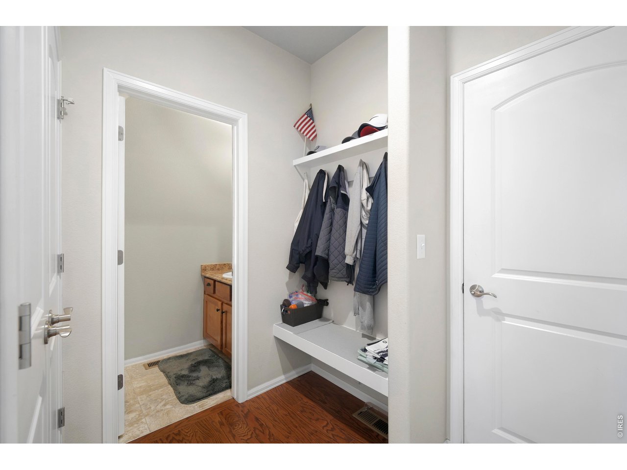 Another Entry Area coming in from the Garage with Coat Storage and Seat, Half Bathroom