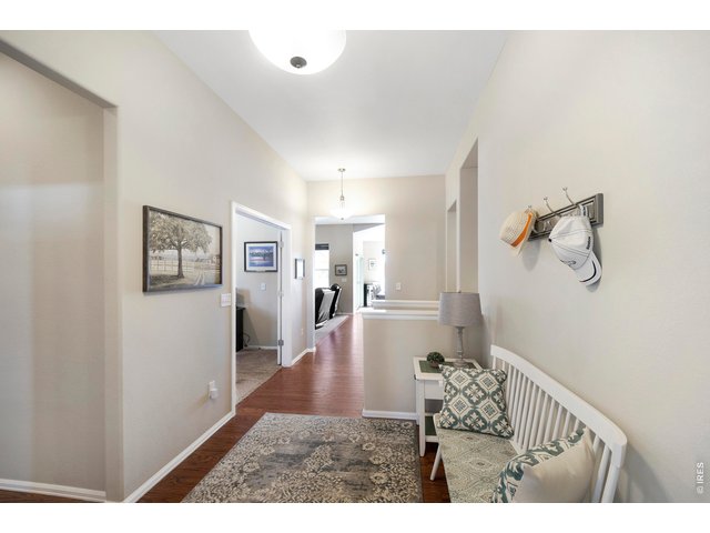 Property Photo 10 Grand Entry into the home, large enough for a bench, lamp and small table. Pretty Hardwood Floors throughout the Entry Way, Kitchen and Dining Room