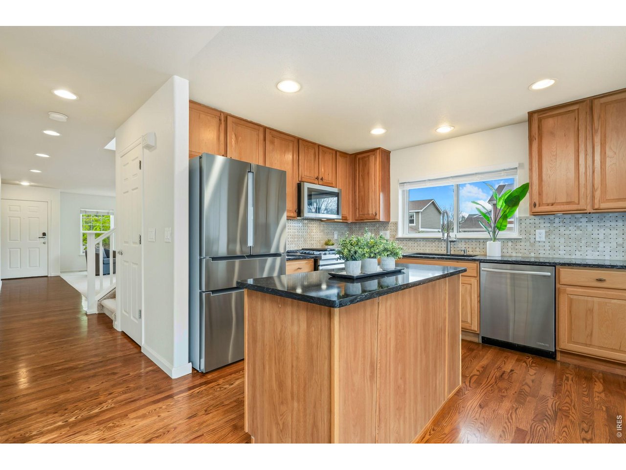 Pecan cabinets, granite countertops, custom backsplash and upgraded appliances