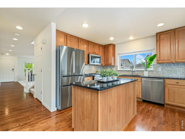 Property Photo 7 Pecan cabinets, granite countertops, custom backsplash and upgraded appliances