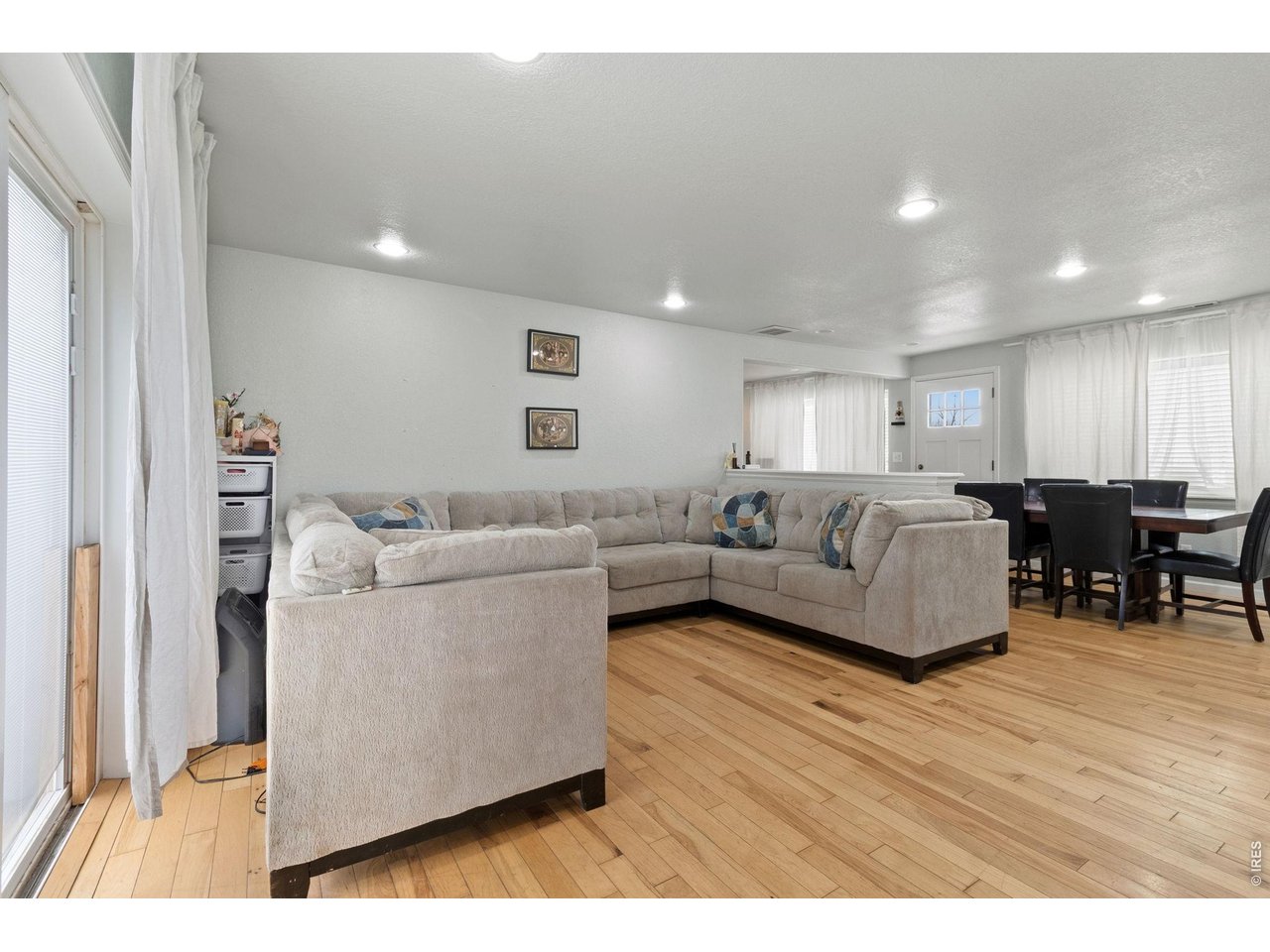 Spacious living area with recessed lighting & ample natural light. Updated hardwood flooring throughout the home. 