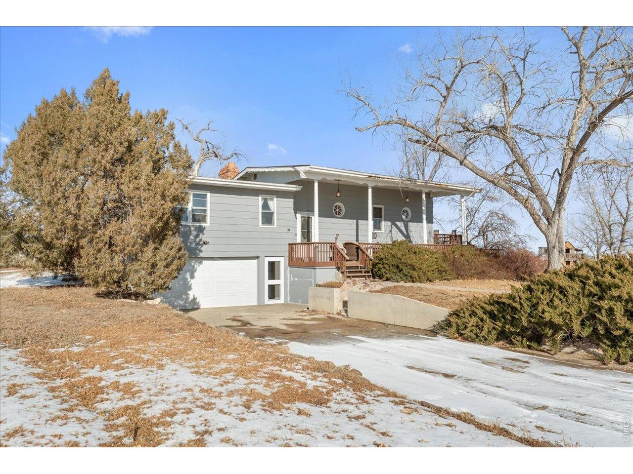 Attached garage fits two cars with storage or enjoy the large concrete parking area in front.