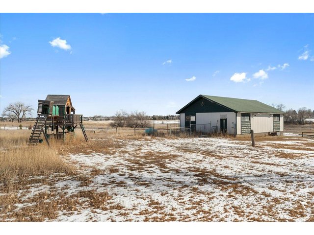 Property Photo 34 Back of shop with small fenced area. Playhouse included or it can be removed.