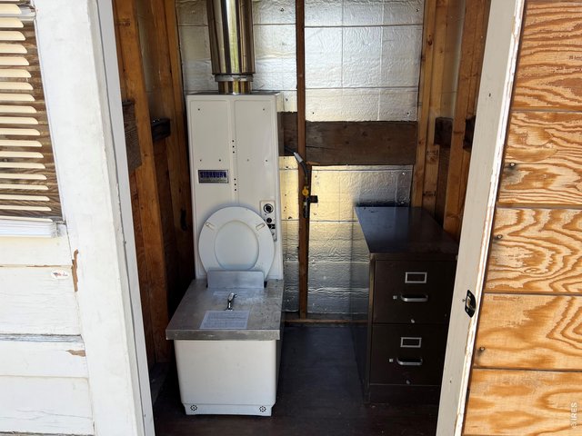 Property Photo 31 Gas-fired incinerating toilet (Storburn brand) in outhouse.