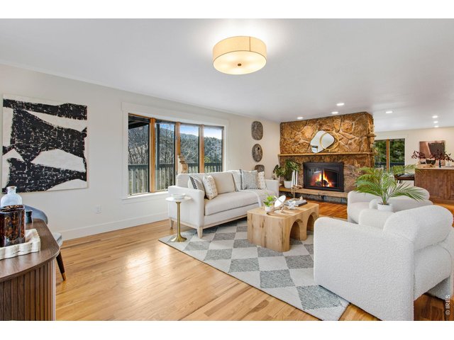 Property Photo 14 The family room w/ moss rock electric fireplace & can lights captures incredible views while the remodeled kitchen features quartz countertops, large center island, breakfast bar, pantry, abundant cabinets, & stainless steel appliances.