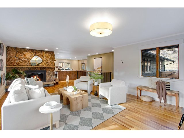 Property Photo 15 The family room w/ moss rock electric fireplace & can lights captures incredible views while the remodeled kitchen features quartz countertops, large center island, breakfast bar, pantry, abundant cabinets, & stainless steel appliances.