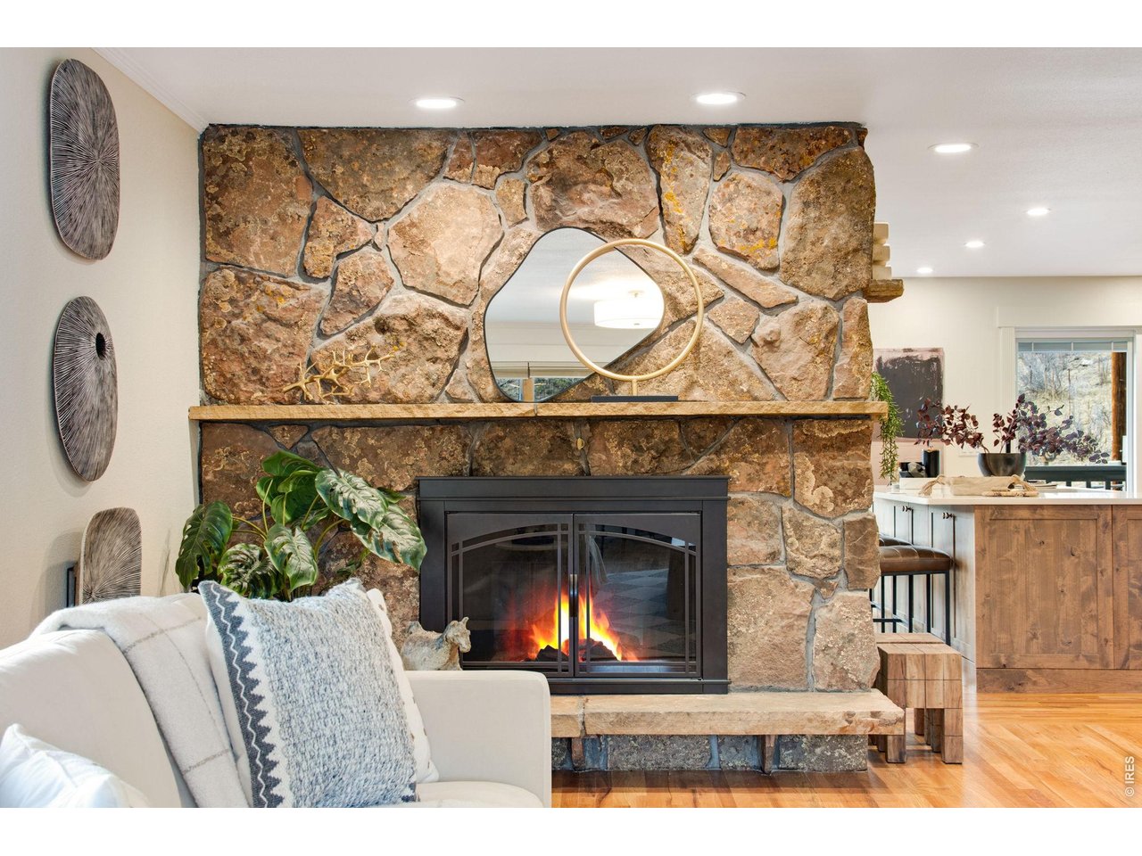 Custom moss rock electric fireplace separating the dining room from main living area. Adds a very cozy, Colorado feel to the home!