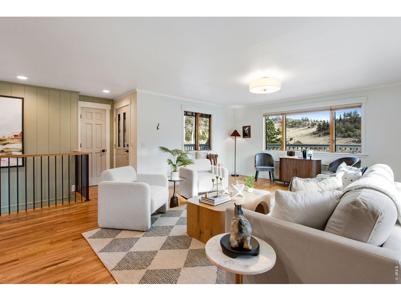 The family room w/ moss rock electric fireplace & can lights captures incredible views while the remodeled kitchen features quartz countertops, large center island, breakfast bar, pantry, abundant cabinets, & stainless steel appliances.