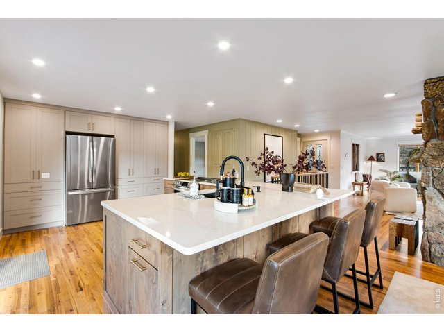 Property Photo 22 Huge center island with breakfast bar and under counter storage cabinets, pantry with sliding organizers, plenty of cabinets with hardware, updated lighting fixtures.