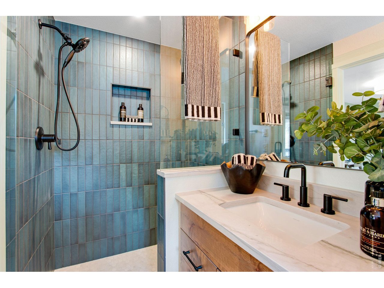 Private and completely remodeled bath featuring quartz countertops, tile flooring, shower with floor to ceiling tile backsplash, and a full length walk-in closet.