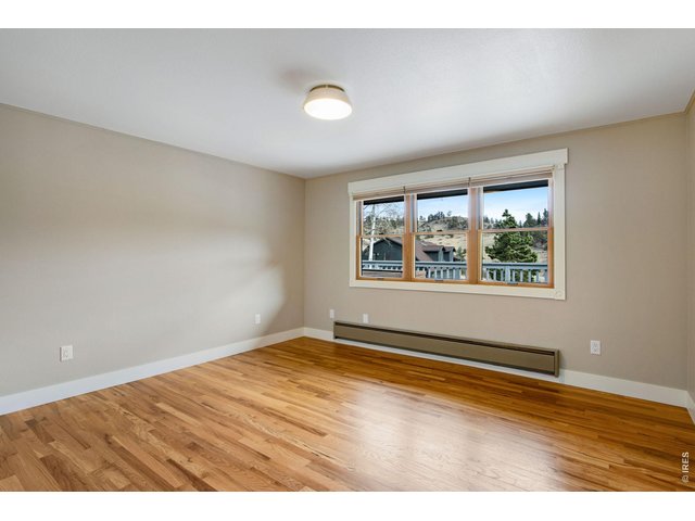 Property Photo 34 Guest bedroom #3 with hardwood floors and ample natural light. Fresh paint!