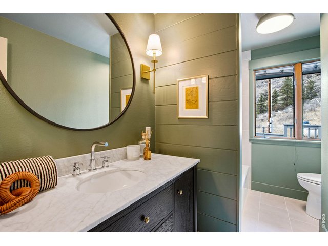 Property Photo 35 Completely remodeled guest full bath on main level features tile flooring, tile backsplash, updated lighting, shiplap accents and a comfort height toilet. Everything is brand new!