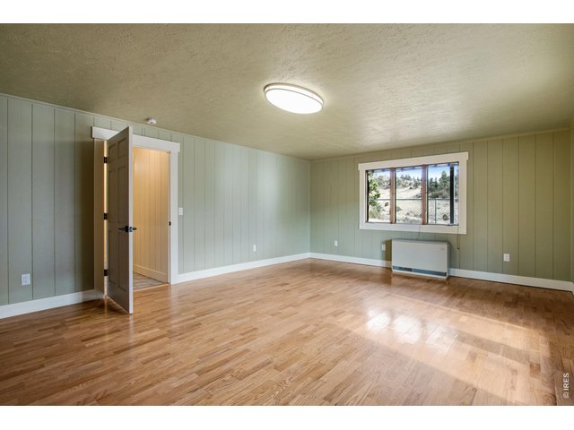 Property Photo 37 Lower level featuers a 4th bedroom, office or gym, laundry, & remodeled 3/4 bath. Hardwood floors, new paint and updated trim!