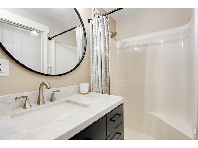 Property Photo 40 Lower level remodeled 3/4 bath with lifted vanity, comfort height toilet and quartz countertop
