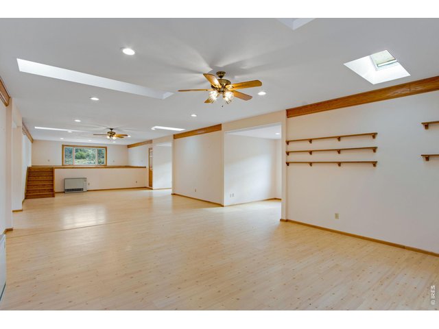 Property Photo 42 Finished loft area in the detached shop/outbuilding, perfect for additional living space, storage, or entertainment. Ample opportunities!