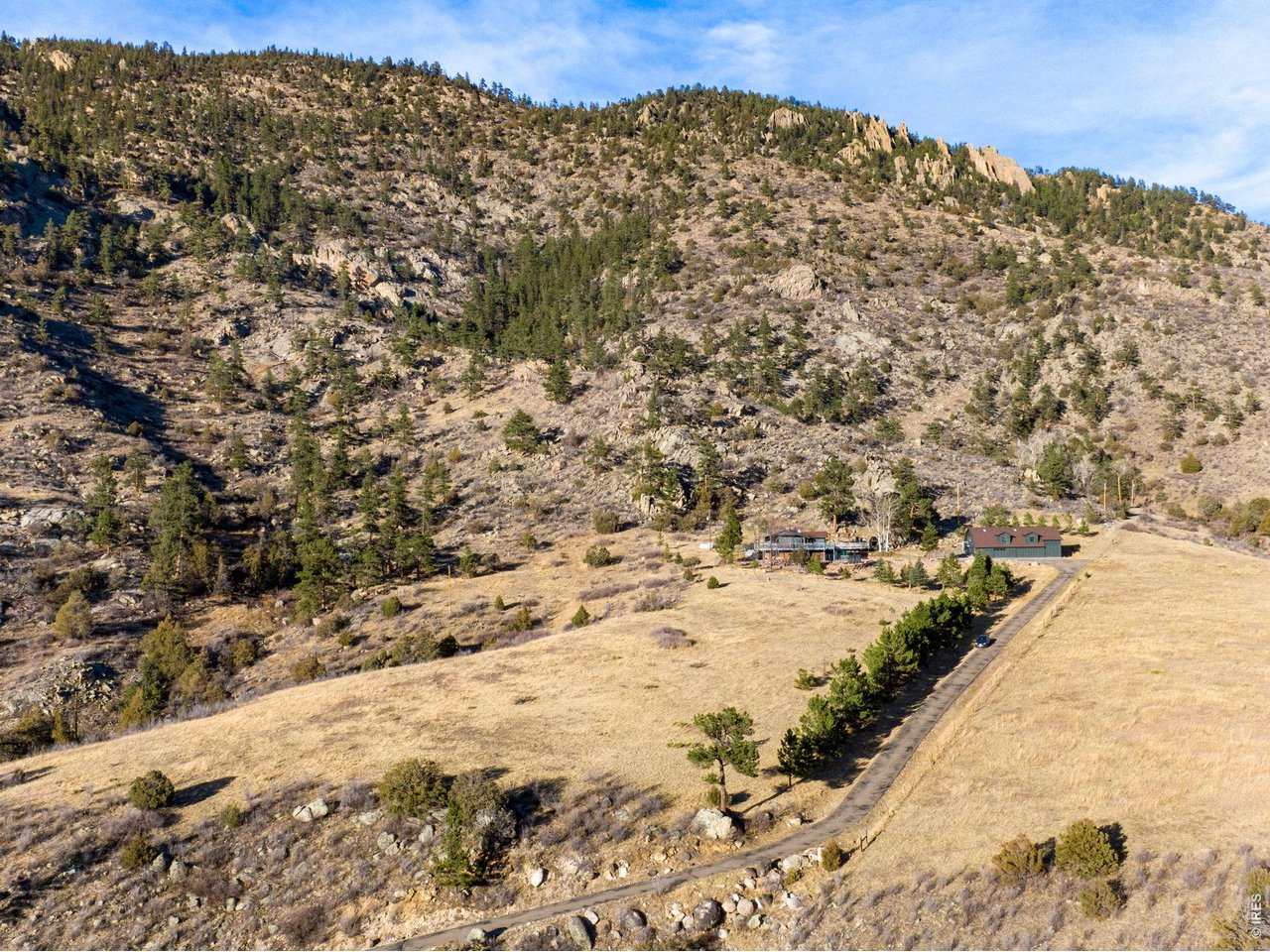 Asphalt driveway leading all of the way up to the home from the highway, a huge benefit for a property in the foothills. Low maintenance and easy to plow!