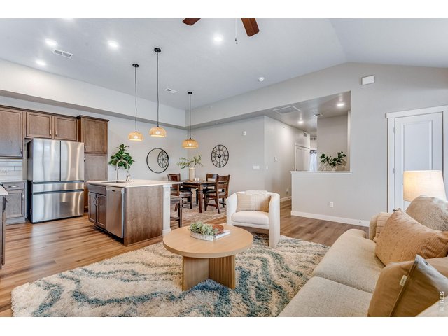 Property Photo 2 Higher ceilings, an expansive living room, oversized high-end 4 door newer stainless steel fridge! Upgraded Low maintenance wood LVP flooring! Beautiful upgrades throughout!