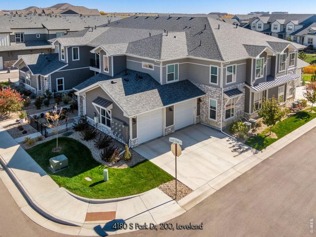Property Photo 12 The west-facing oversized single-car garage is fully insulated + sheet-rocked with an insulated door panel, perfect for Colorado seasons-while acres of HOA-protected open space to the south create a peaceful backdrop with immediate trail access.